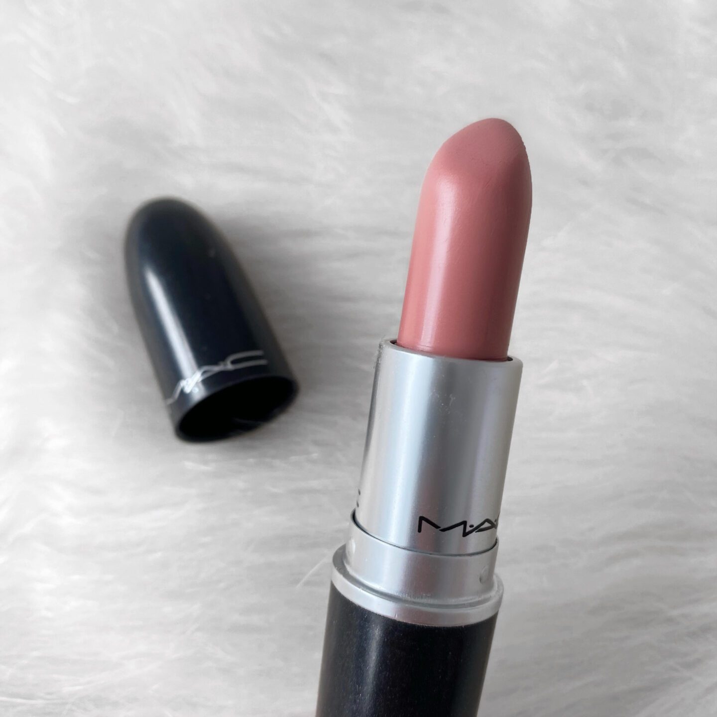 Close up of MAC Creme Cup lipstick bullet showing a light blue pink