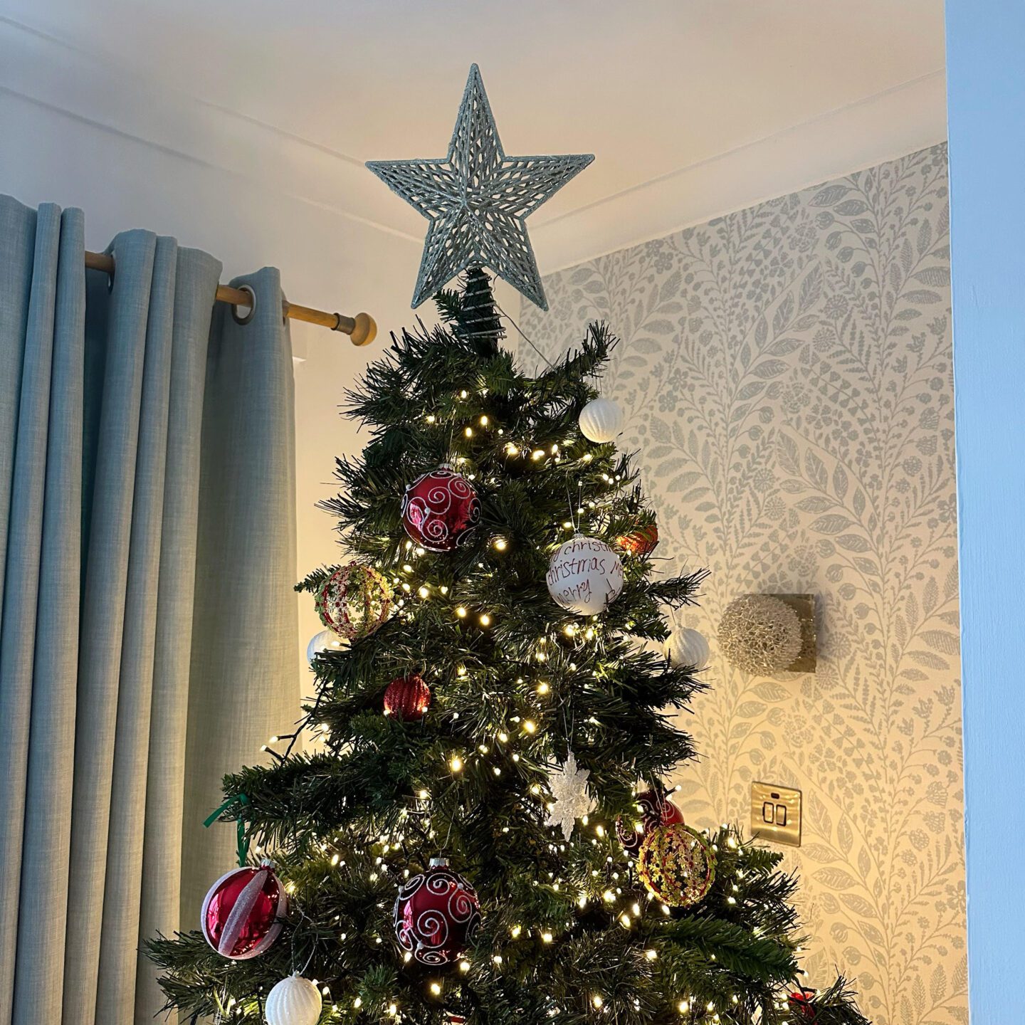 The wonderful Christmas tag. Christmas tree with red and white baubles with star on the top.