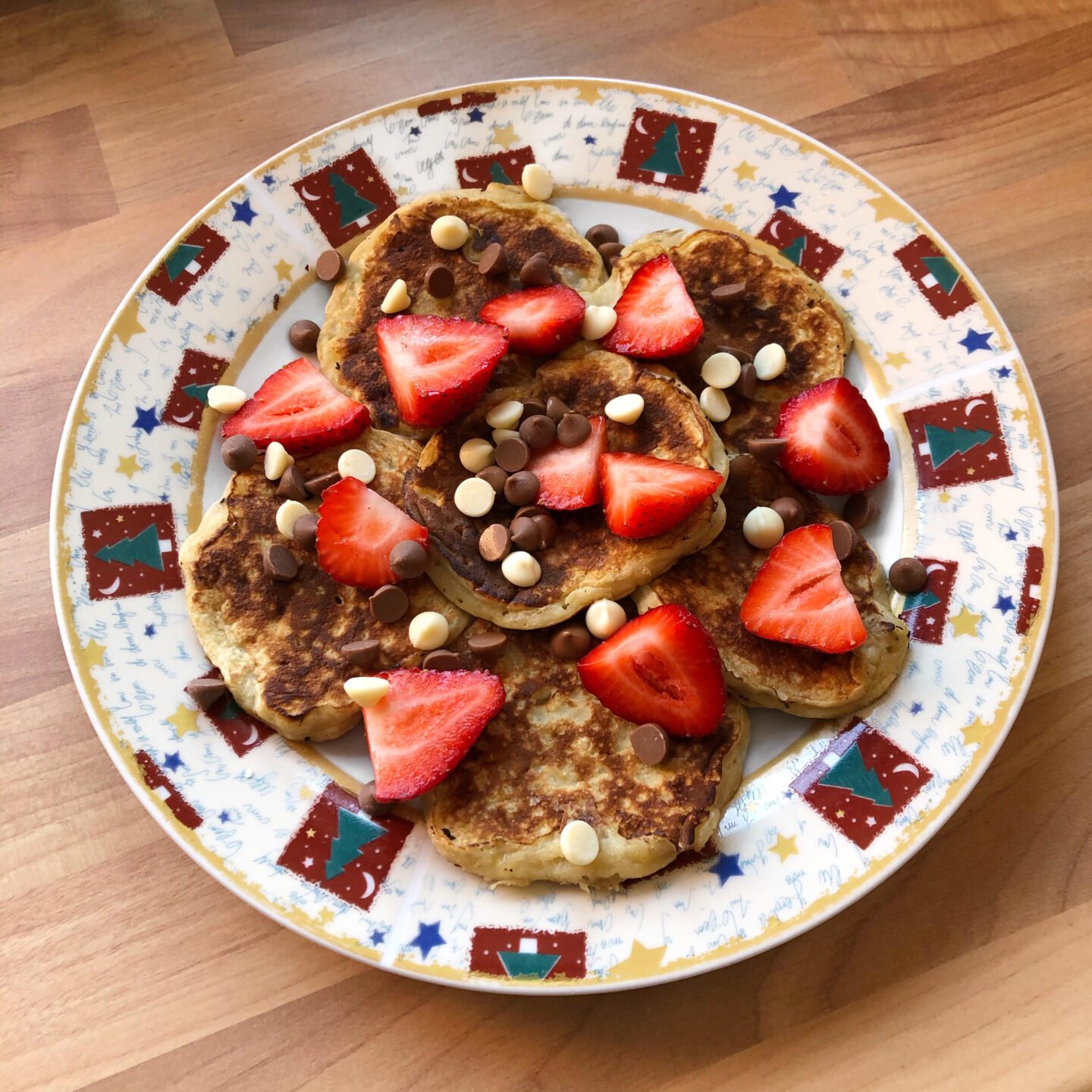 Banana pancakes with strawberries and chocolate chips