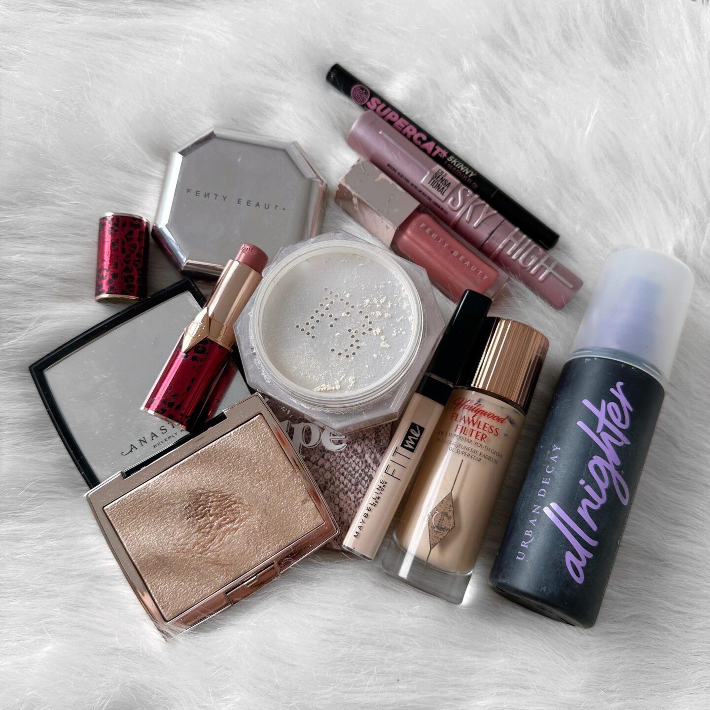 makeup flatlay of all 10 products from my project pan 2023