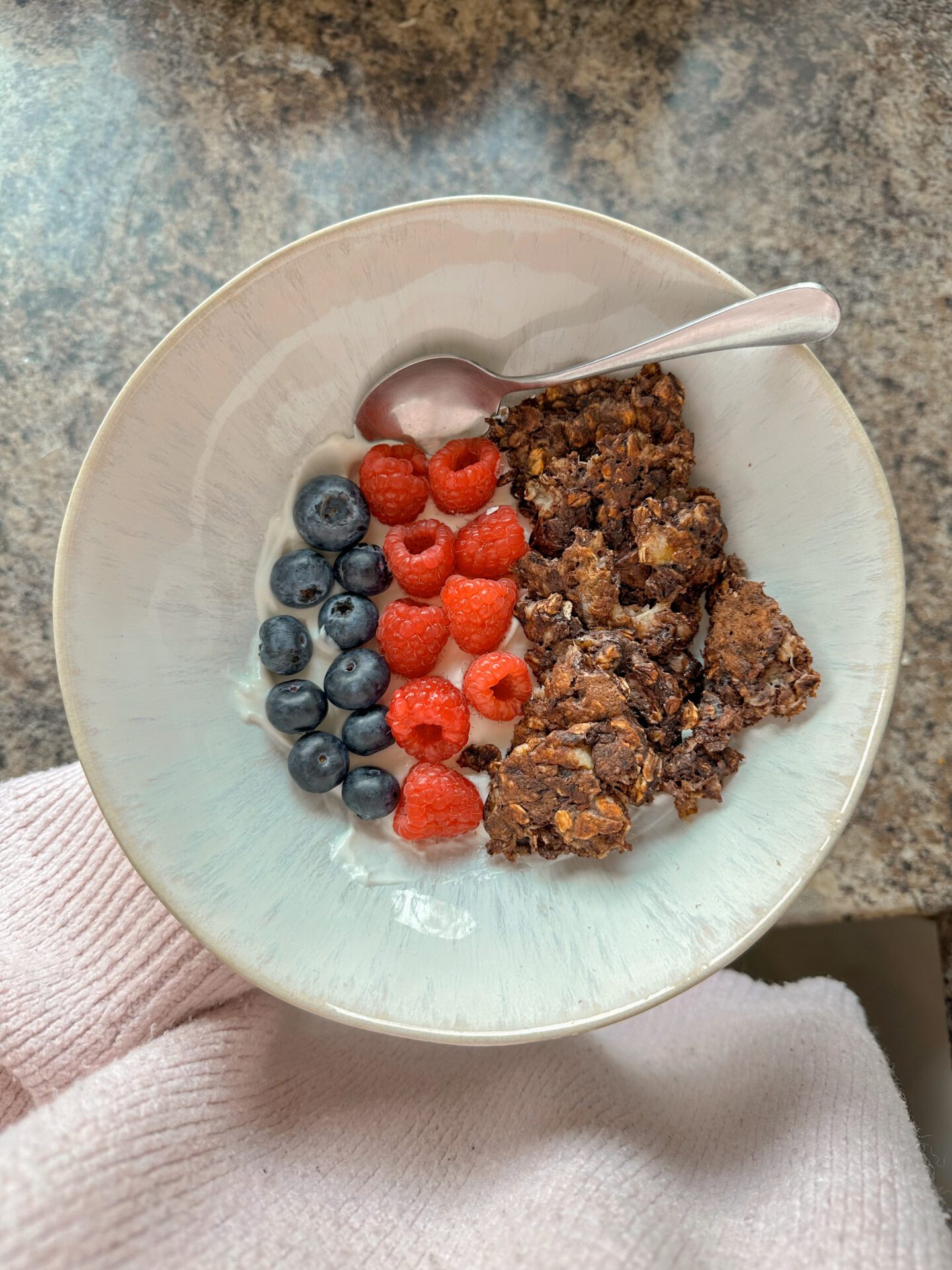 bowl on kitchen side with yogurt, fruit and scrambled oats